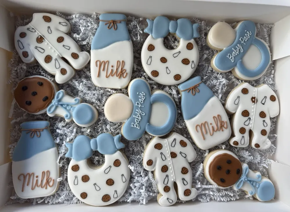 Blue milk-and-cookies baby shower cookies with bottles, onesies and pacifiers, hand-decorated by Kristin